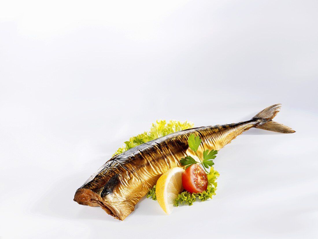 A smoked mackerel with salad garnish