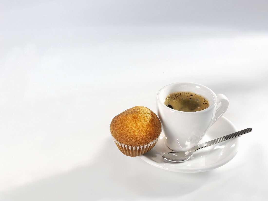 An espresso with a mini-muffin