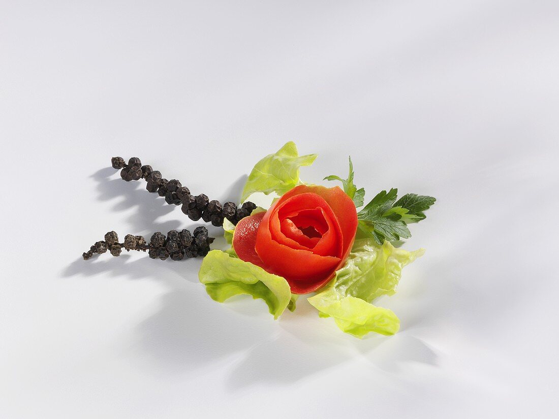 Tomato rose with lettuce leaf and bunches of pepper