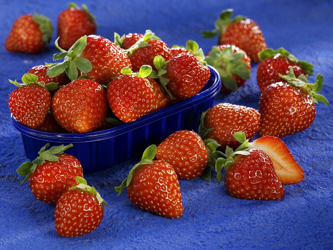 Fresh strawberries in and beside punnet