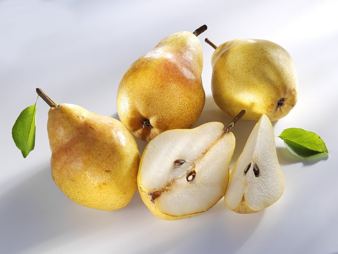 Three whole Williams pears and one cut into pieces