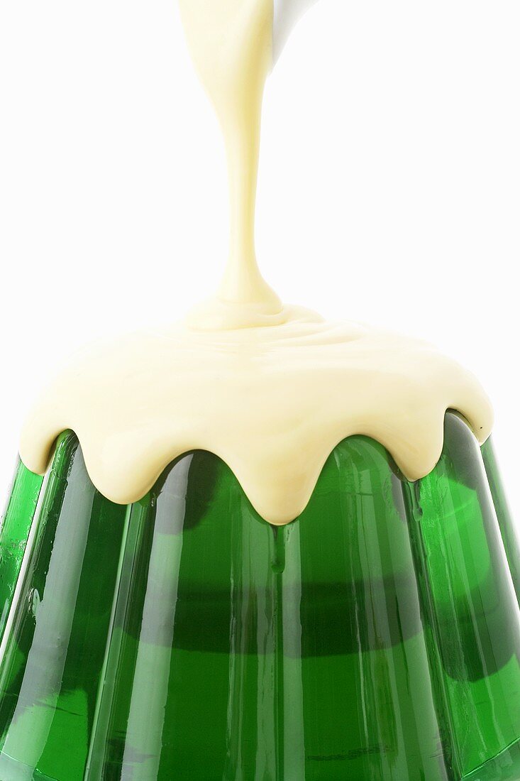 Pouring custard over woodruff jelly