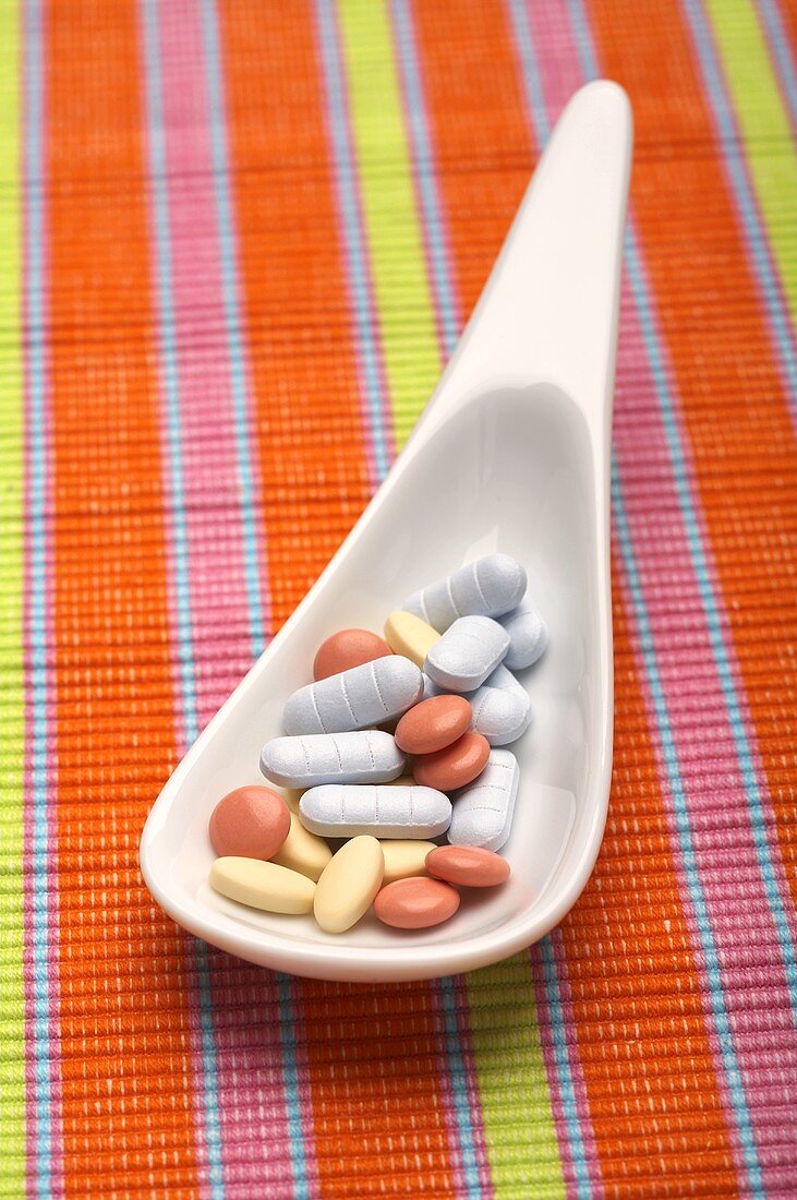 Assorted tablets on a spoon