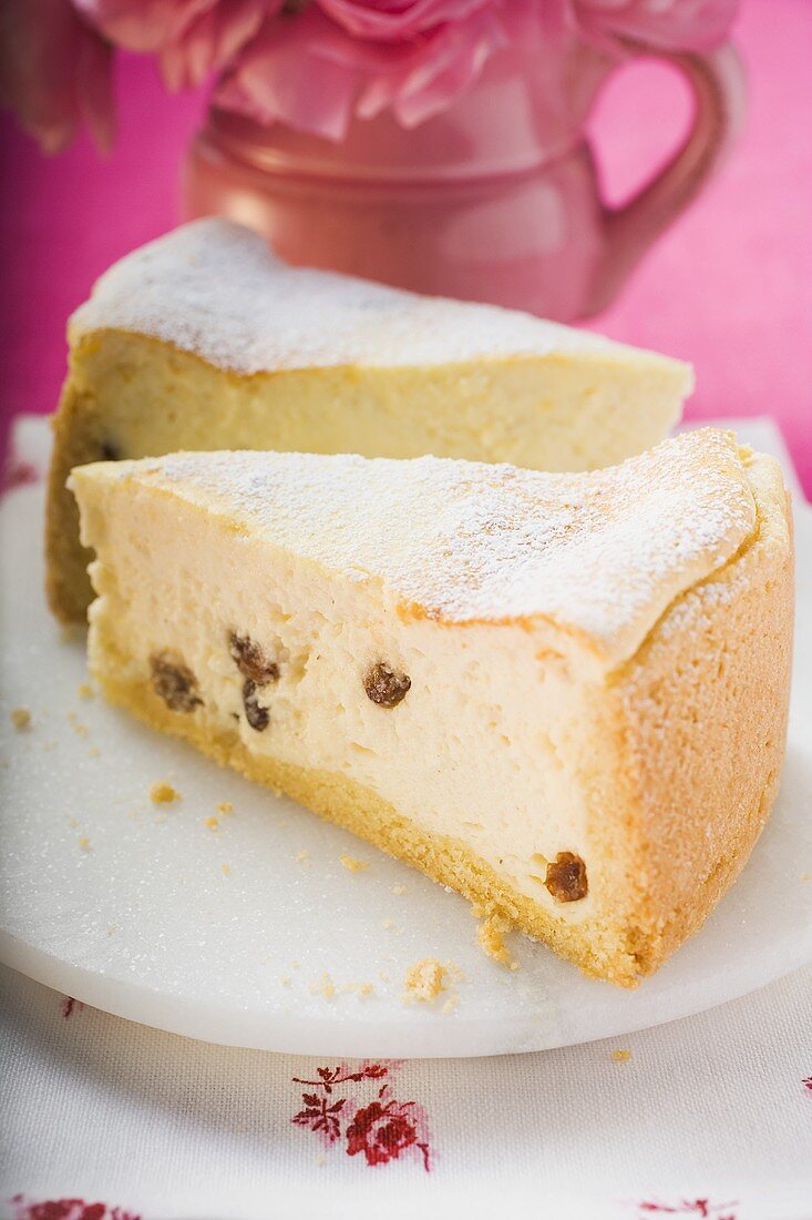 Two pieces of cheesecake with raisins