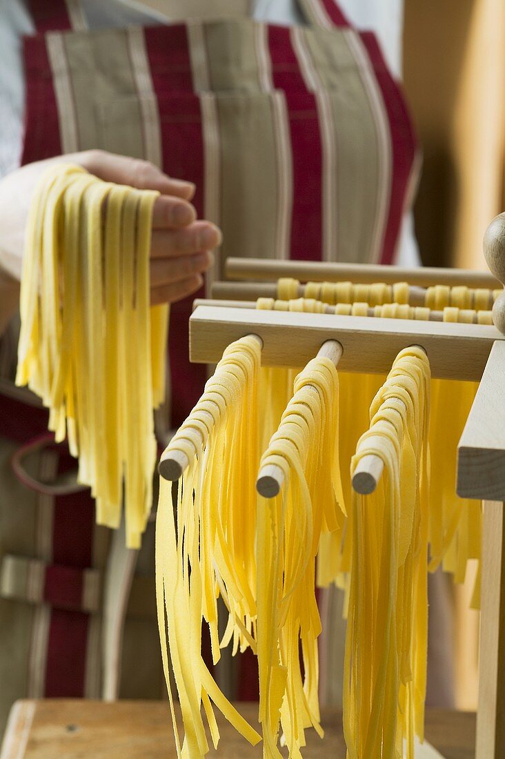 Hanging up ribbon pasta to dry