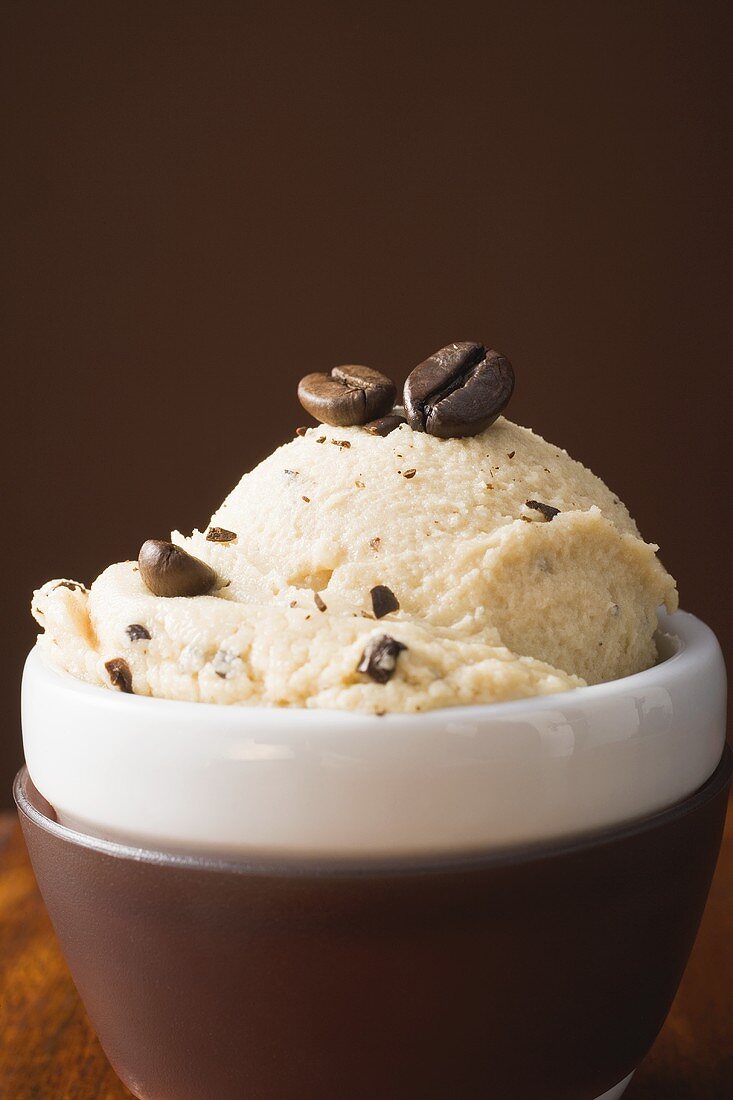 Stracciatella ice cream with coffee beans in dish