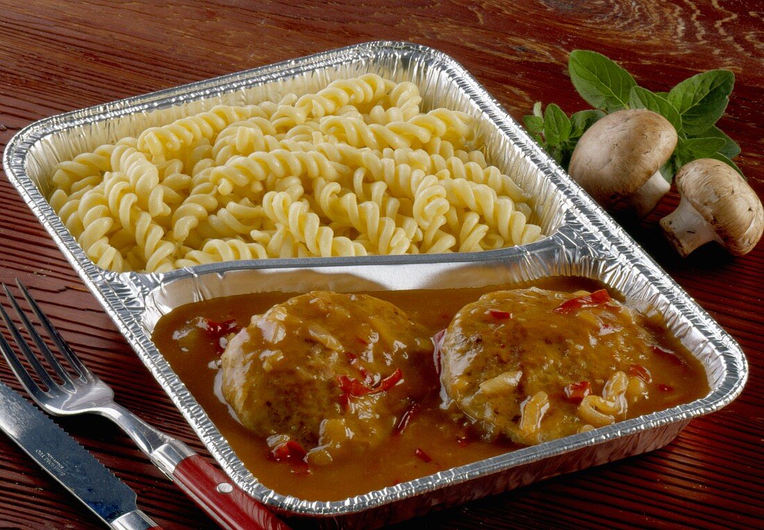 Burgers with gypsy sauce and pasta in aluminium dish