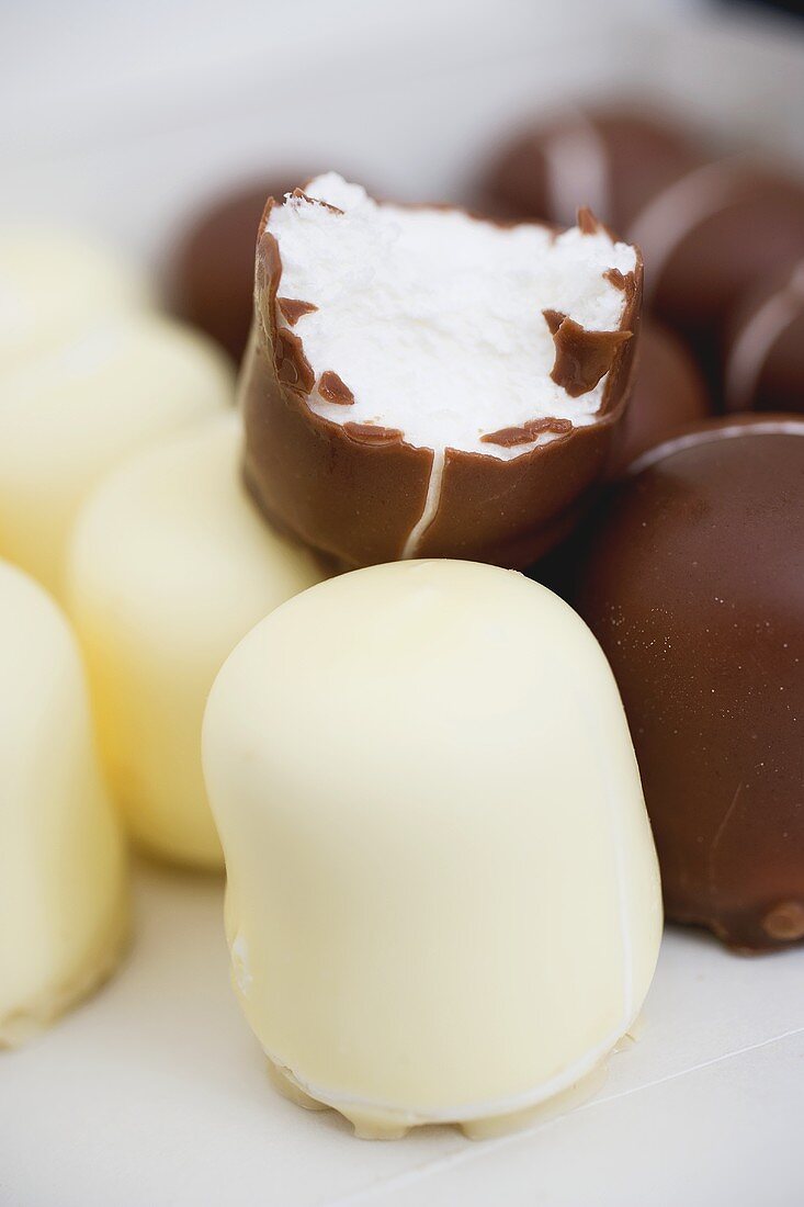 Mini-Dickmanns (chocolate covered marshmallows), one with a bite taken