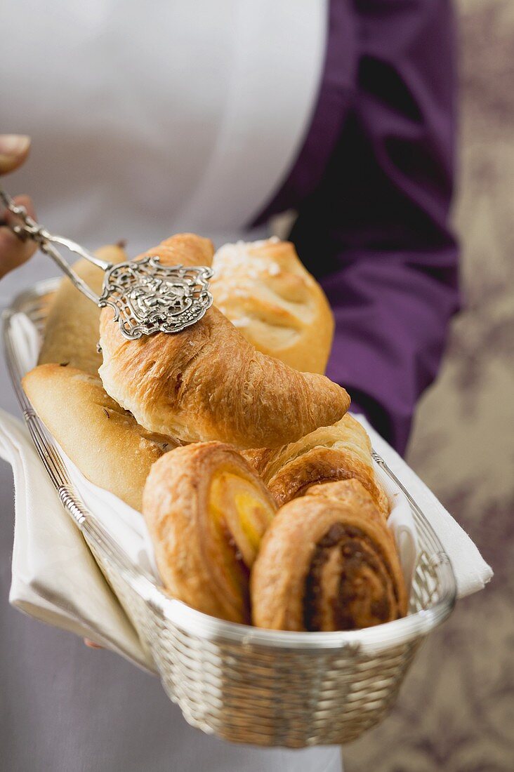 Croissants and Danish pastries in a small basket