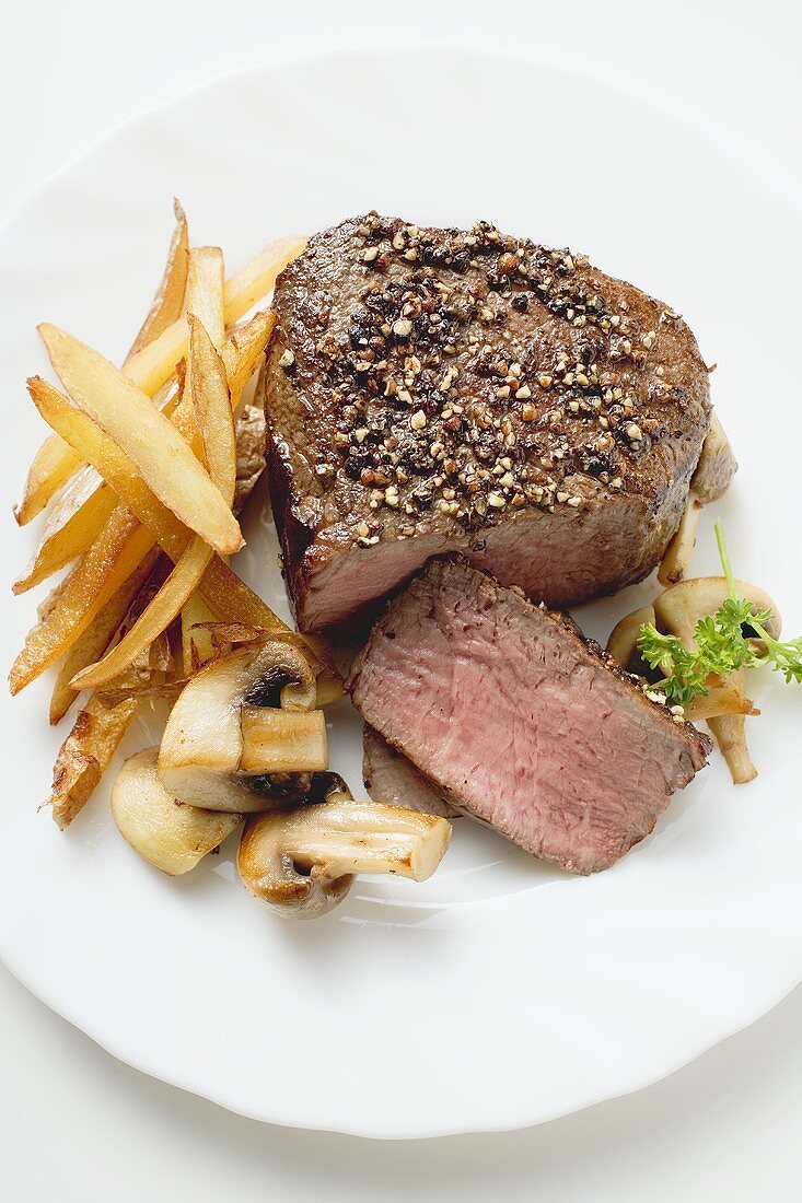 Beef fillet with pepper crust, chips and mushrooms
