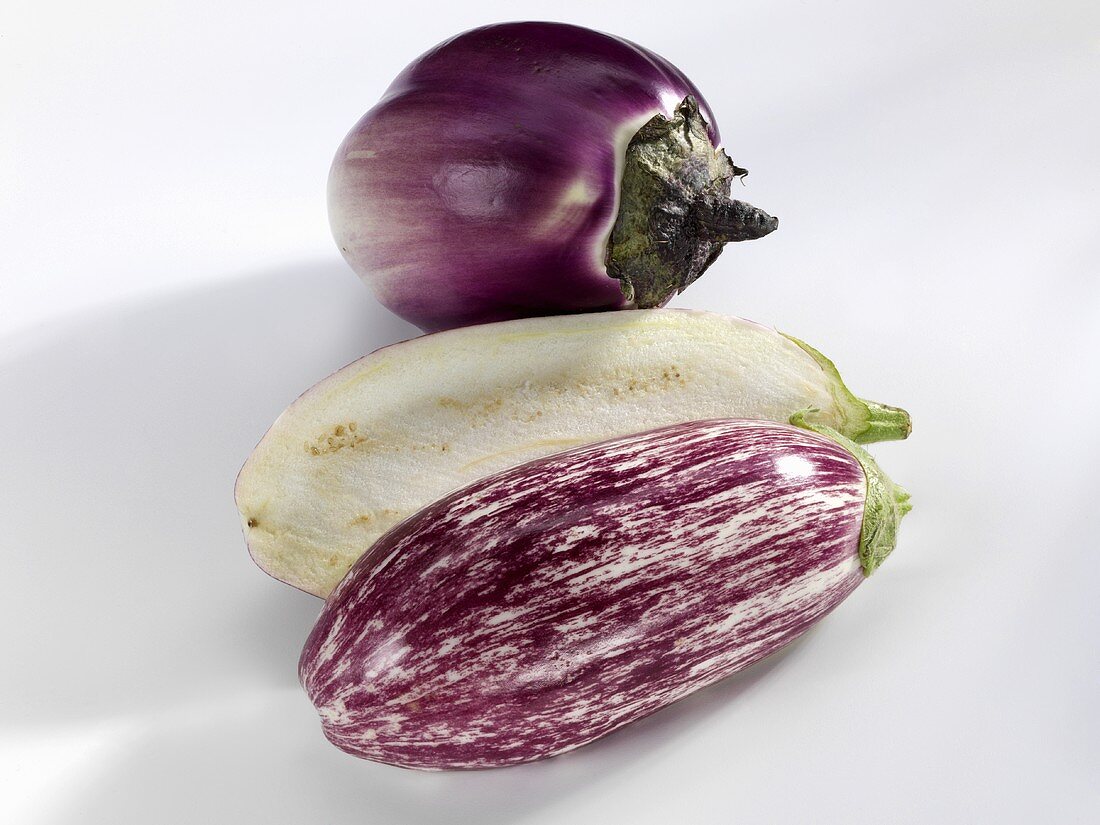 Whole and halved aubergines