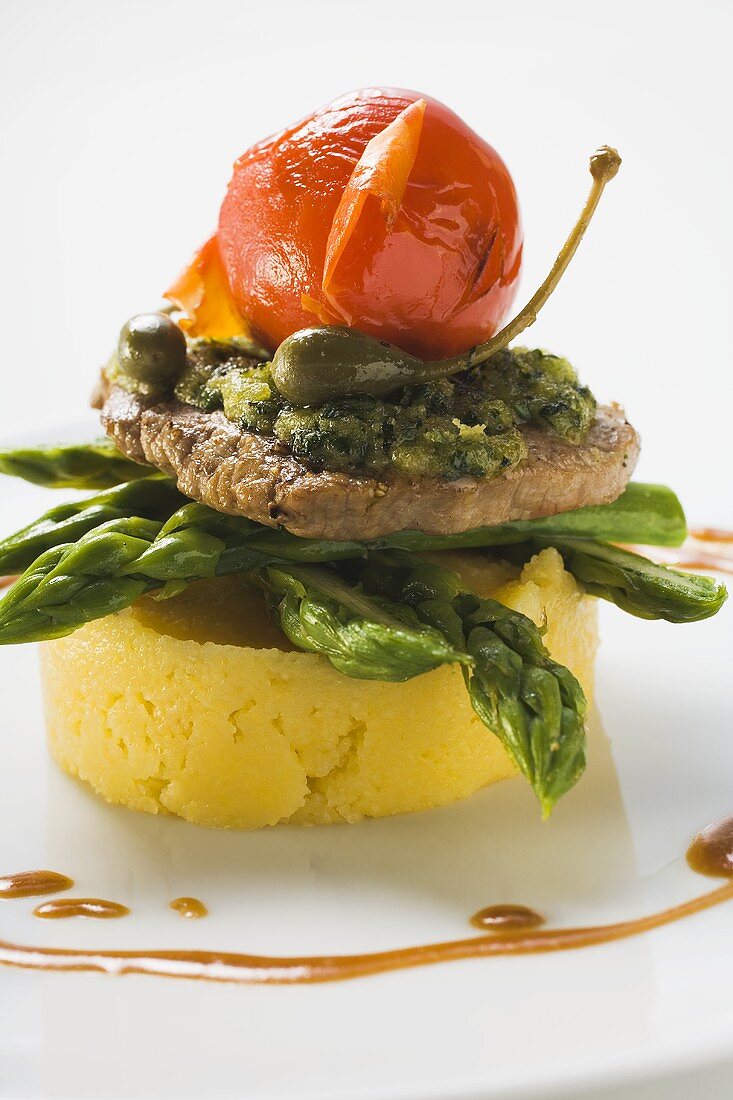 Veal escalope with herb crust on polenta and asparagus