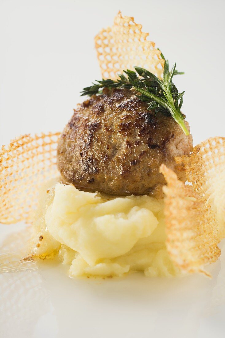 A meatball on mashed potato