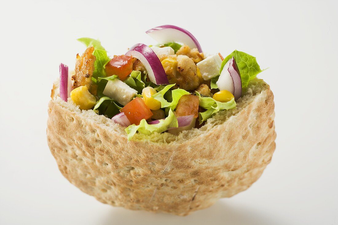 Pita bread filled with vegetables and roast turkey breast