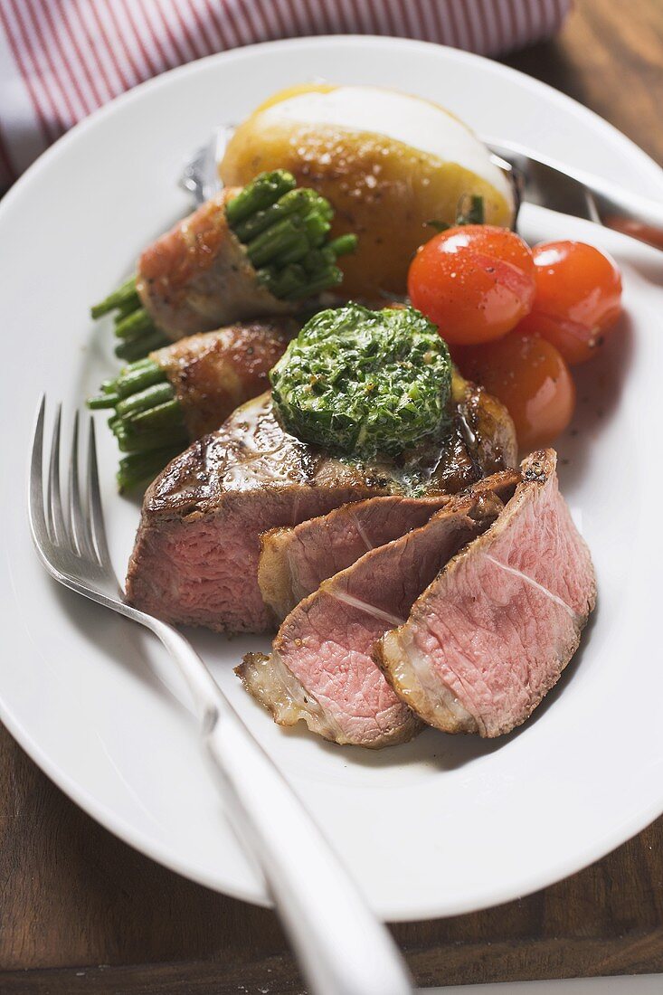 Beef steak with herb butter and baked vegetables