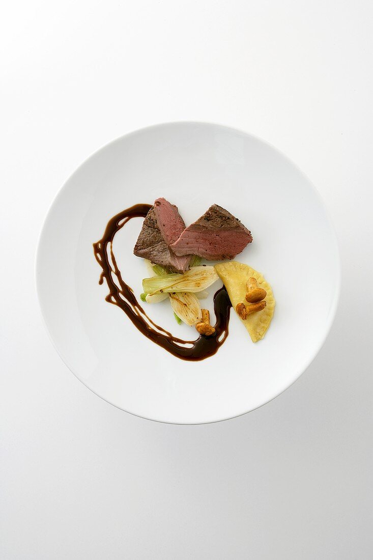 Roasted venison medallion with fennel and ravioli