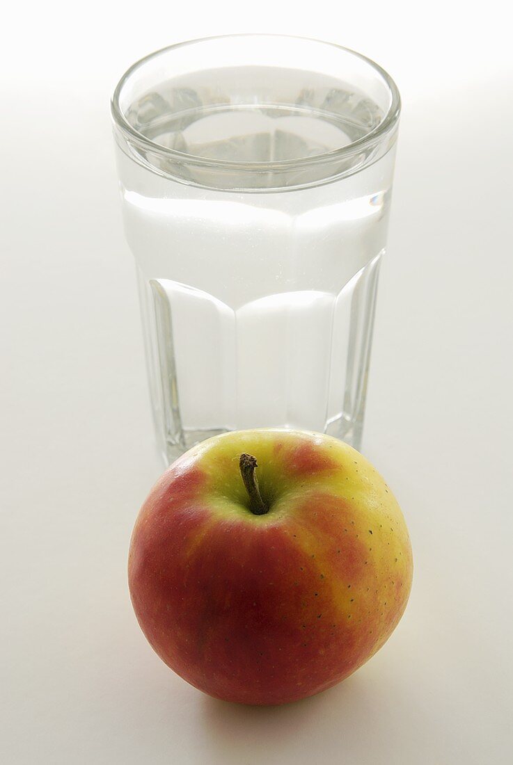 An apple and a glass of water