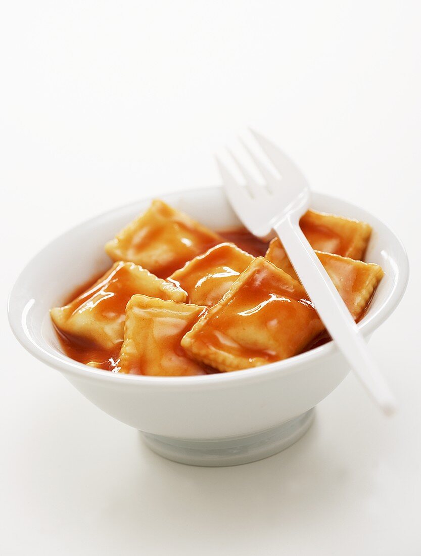 Ravioli in tomato sauce in a small bowl