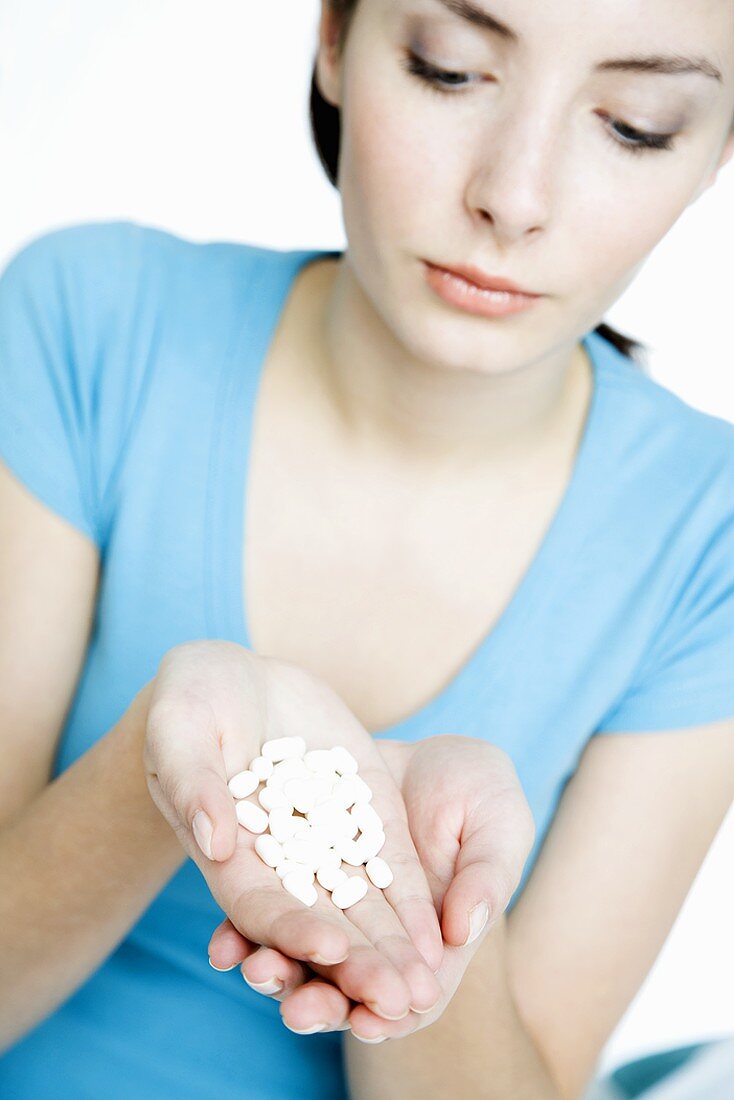 Young woman with tablets in her hand