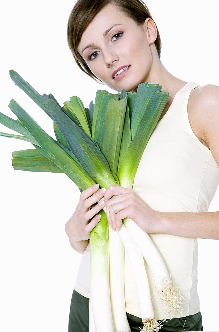 Young woman with fresh leeks
