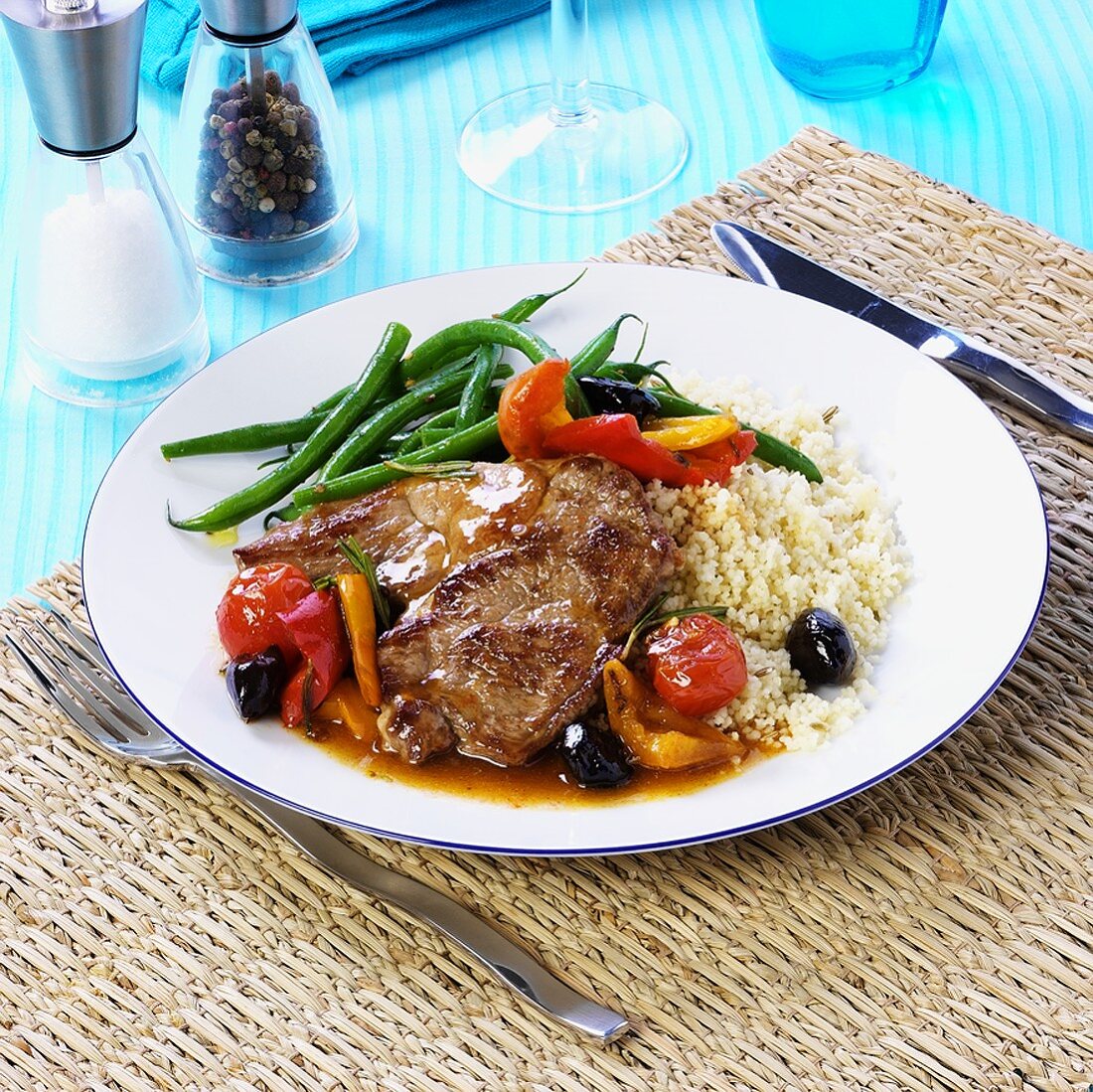 Pork neck steak with couscous and roasted vegetables