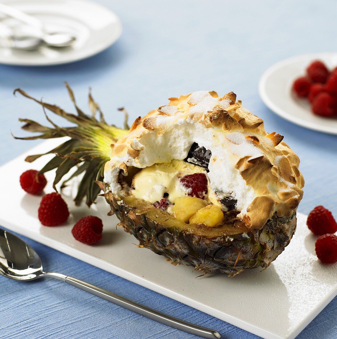 Vanilla ice cream & fruit under baked meringue in pineapple