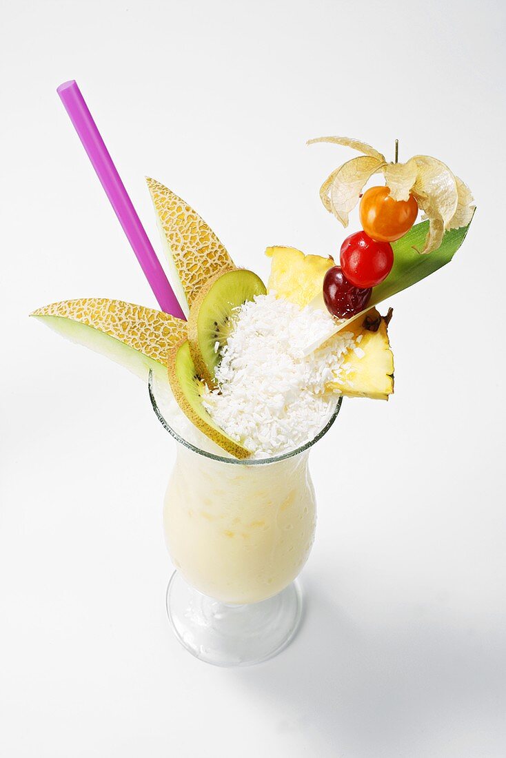 Pina Colada mit Früchten und Kokosflocken garniert