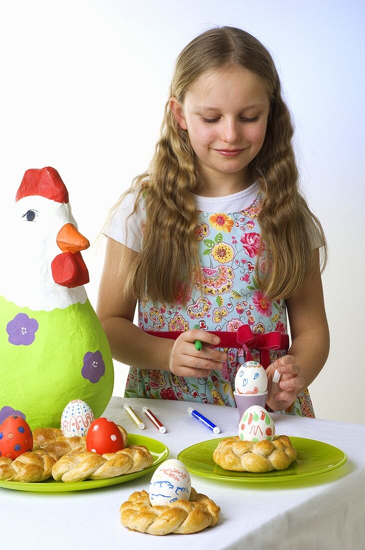 Girl decorating Easter eggs