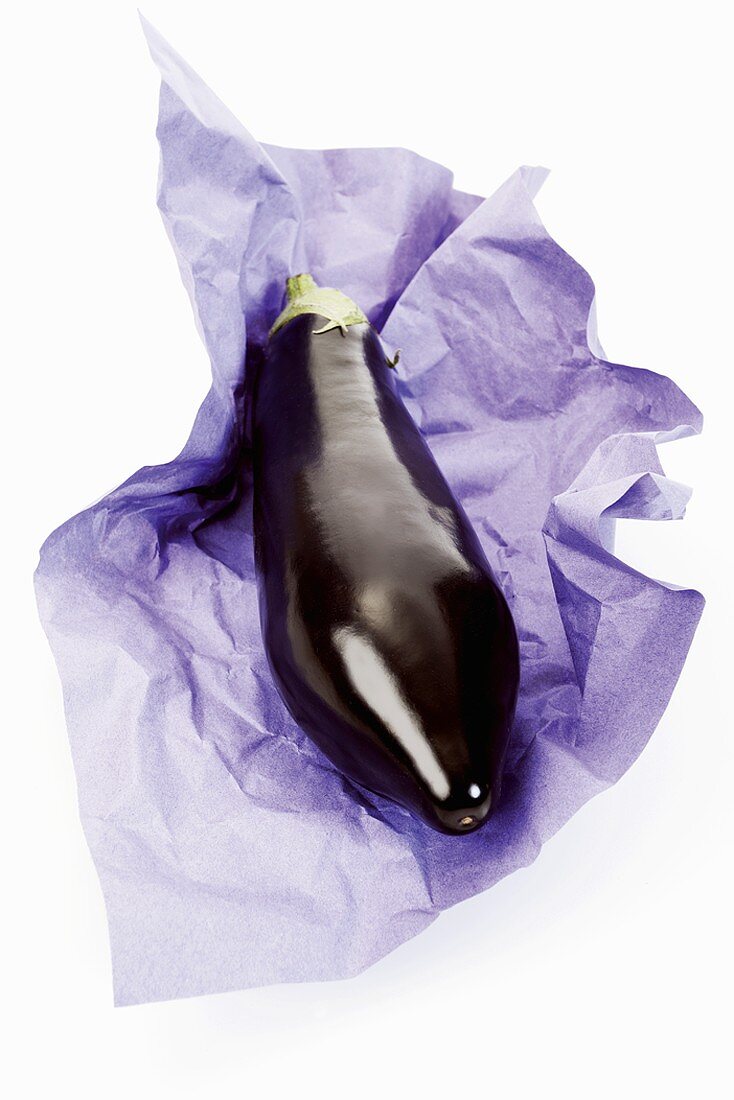 An aubergine on purple paper