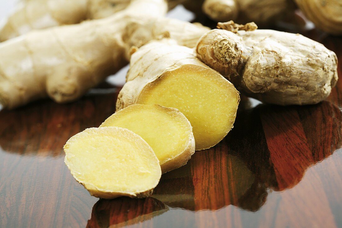 A ginger root, partly sliced