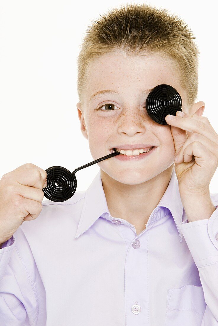 Boy with two liquorice wheels