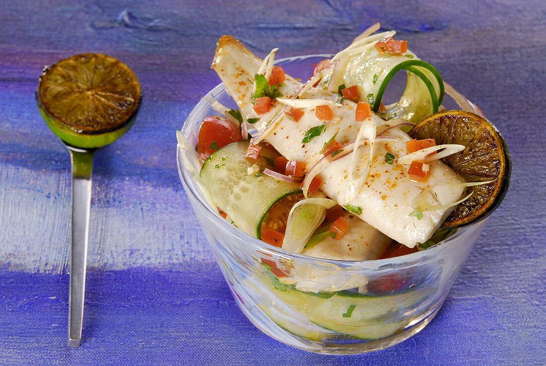 Fried trout fillet on tomato and cucumber salad