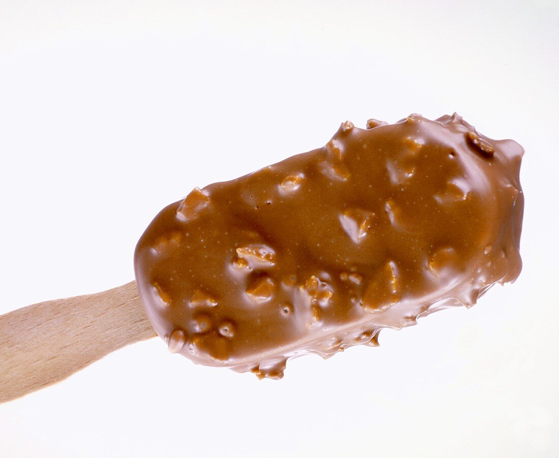 Chocolate-coated nut ice cream on stick