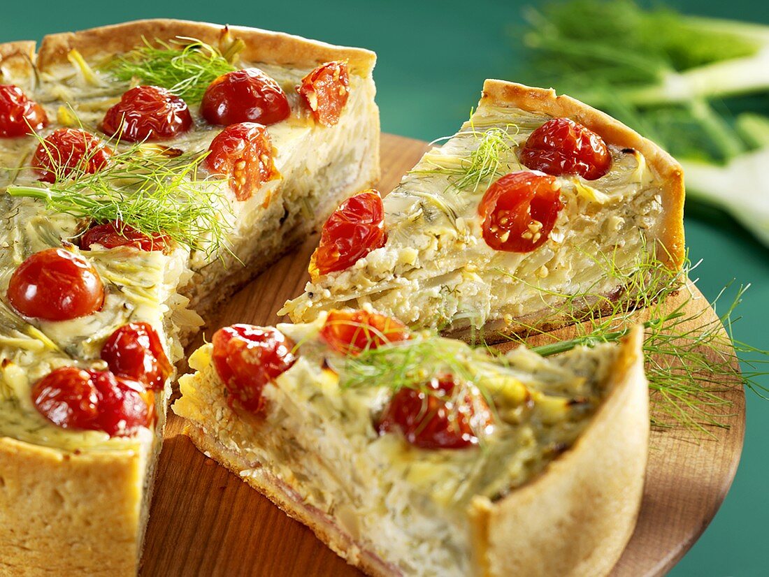 A fennel and tomato tart, partly sliced