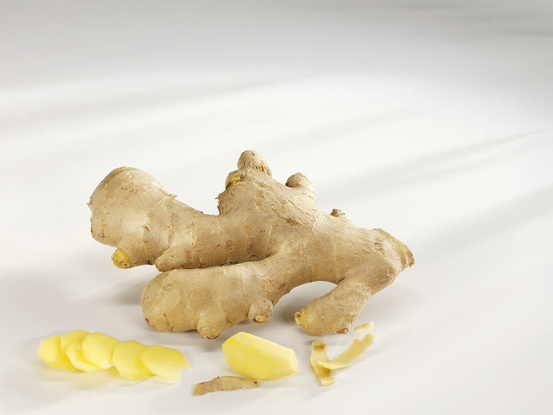 Ginger root with a piece and slices of ginger