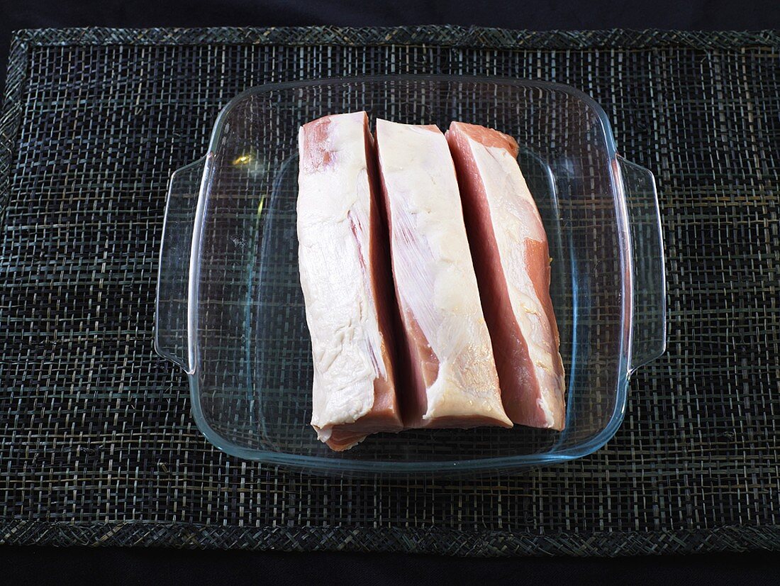Slices of pork in a heat-resistant glass dish