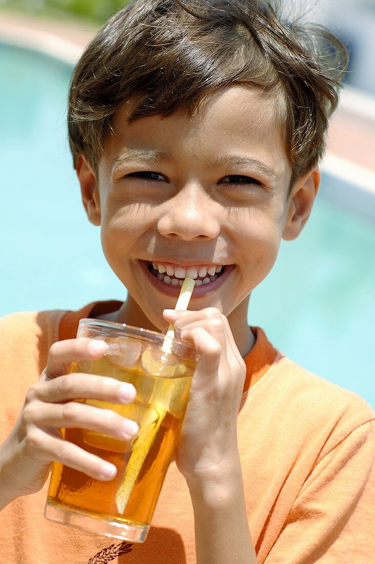 Boy drinking a glass of iced tea