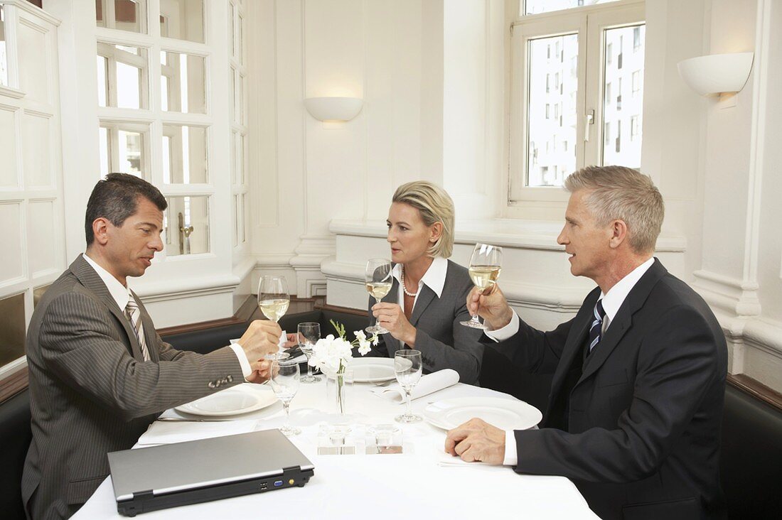 Three business people eating a meal together
