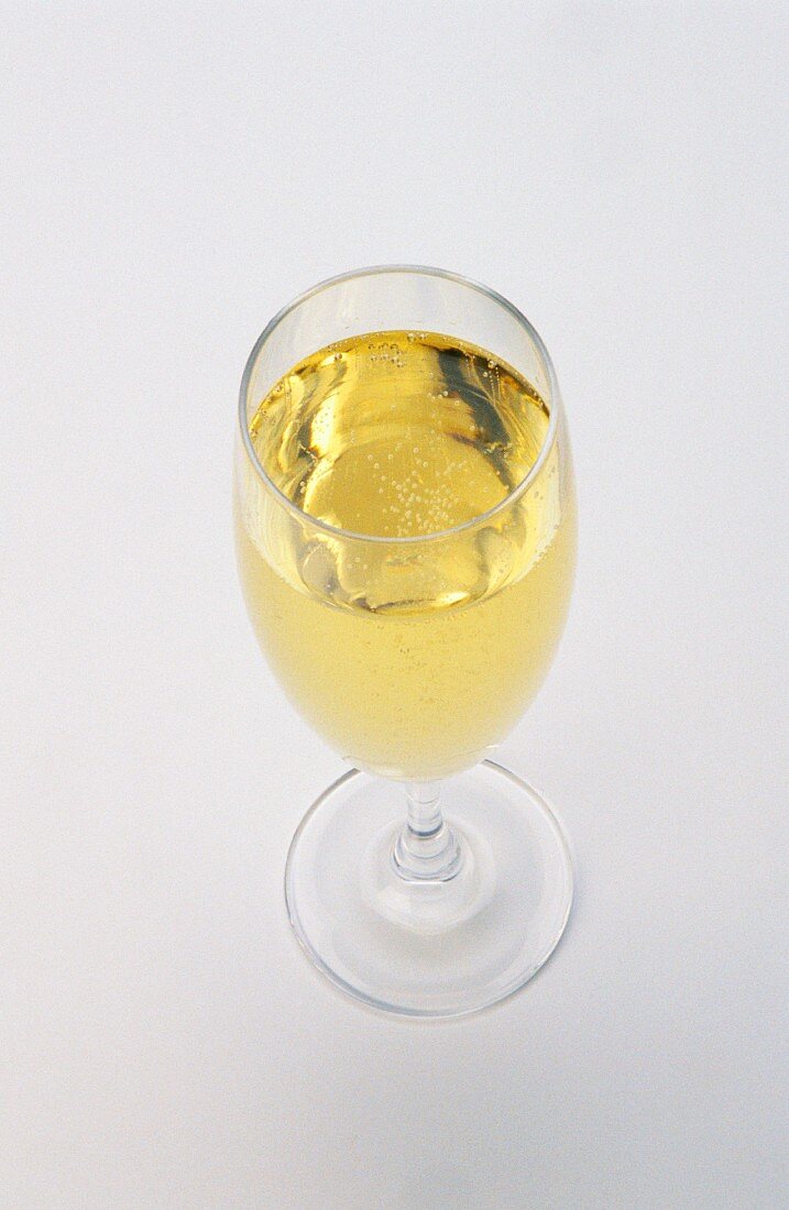 A glass of sparkling wine in a champagne flute