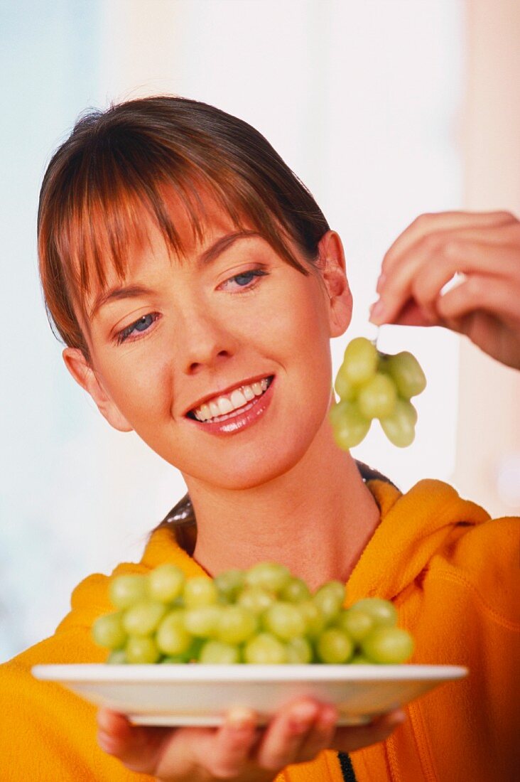 Woman with dessert grapes