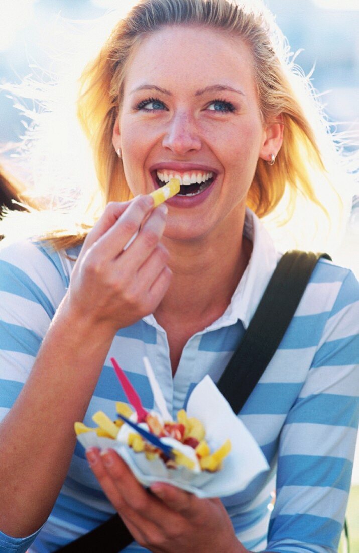 Blonde woman eating chips