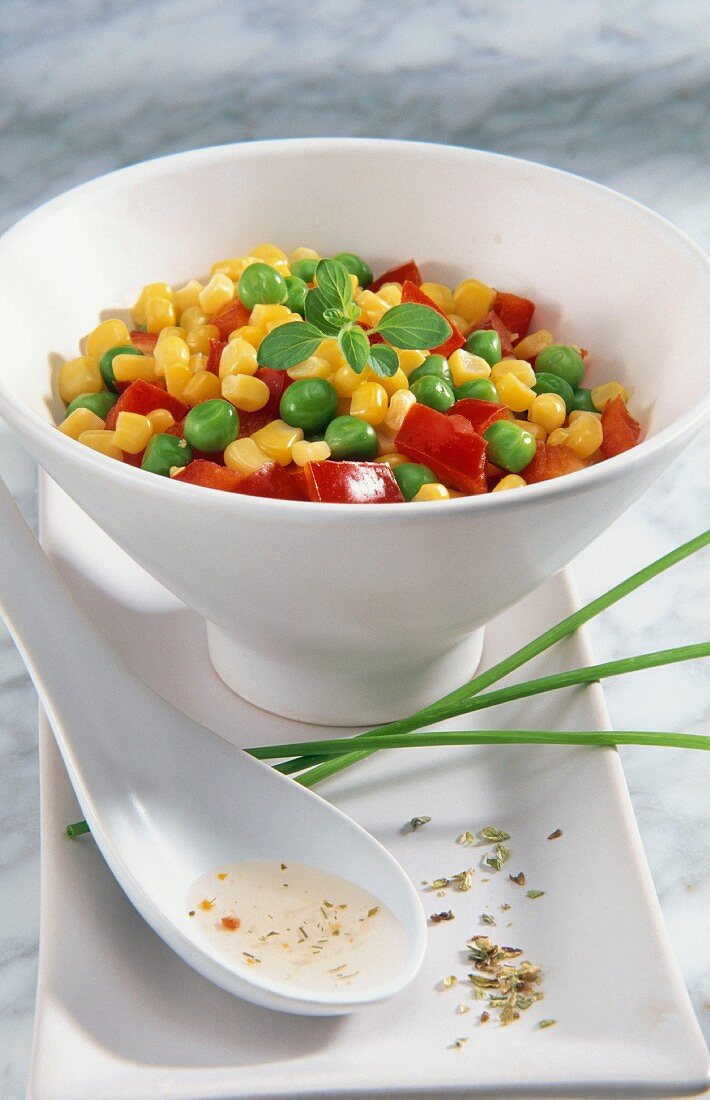 A bowl of sweetcorn, peas and diced peppers