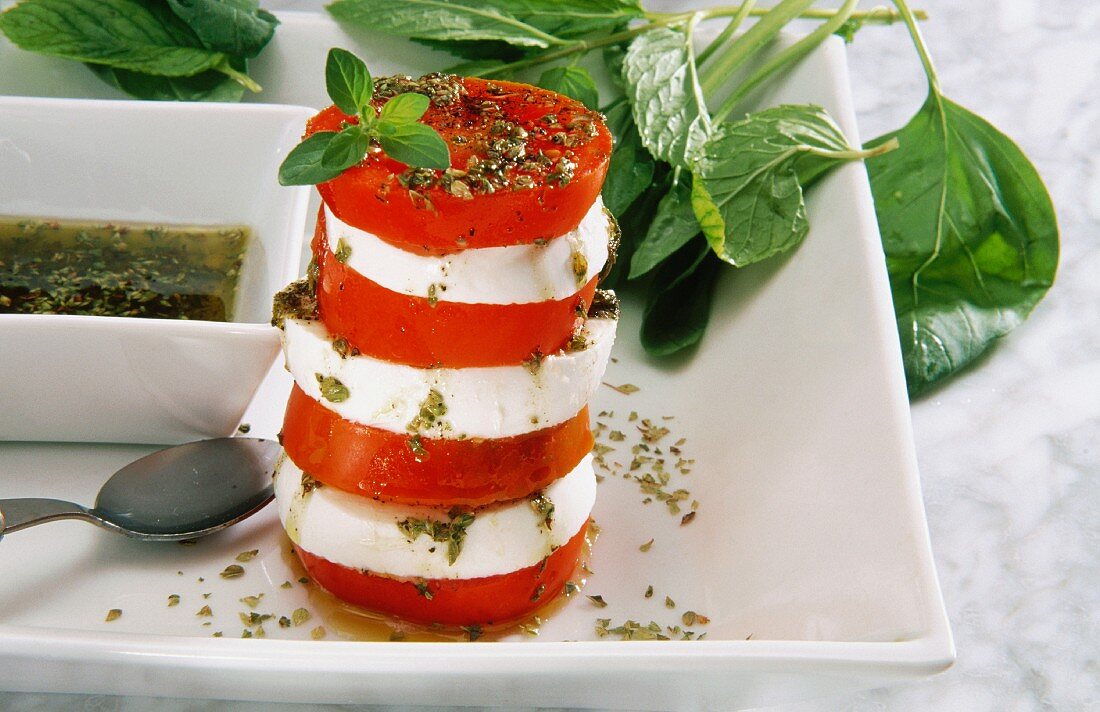 Tomato and mozzarella tower with basil and pesto