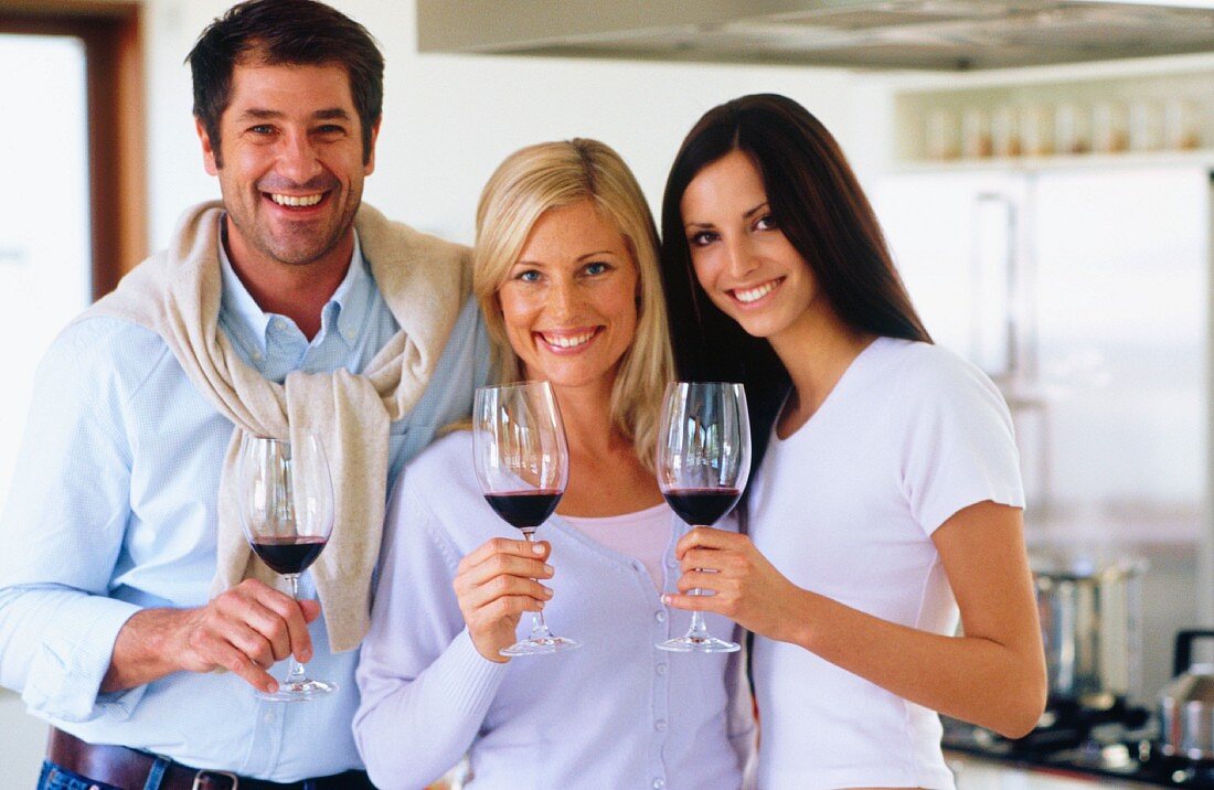 Man and women with glasses of red wine