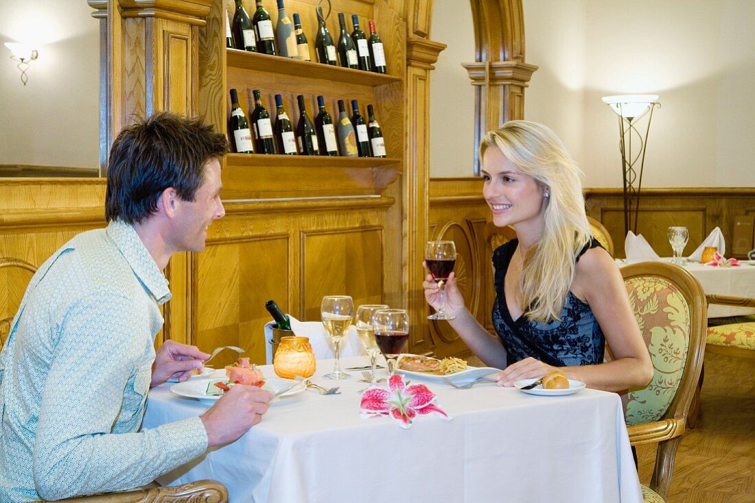 Couple enjoying dinner at wine at a restaurant