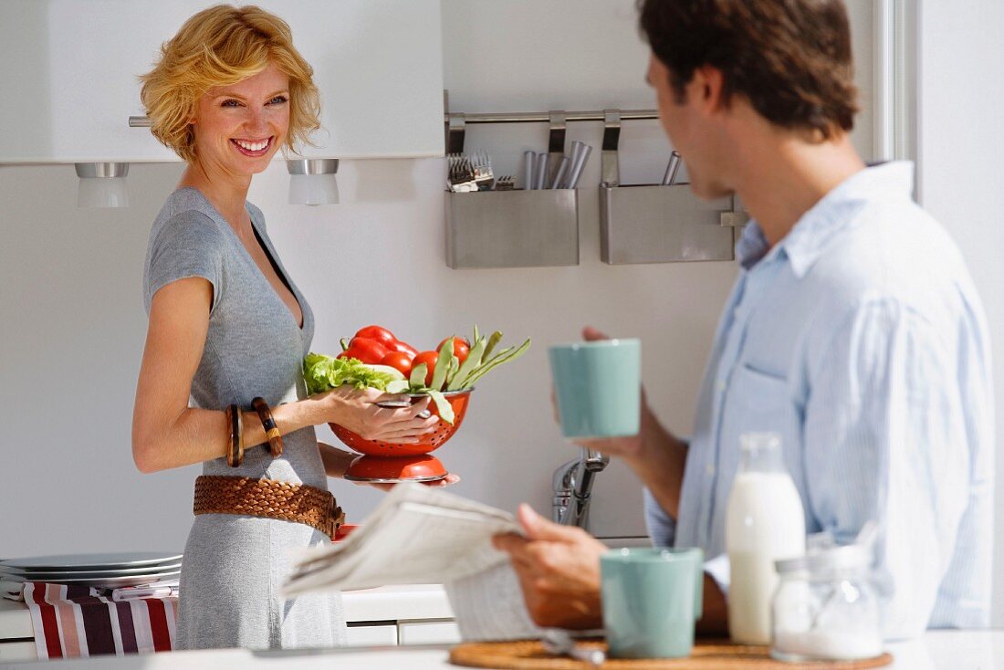 Couple preparing vegetables in kitchen