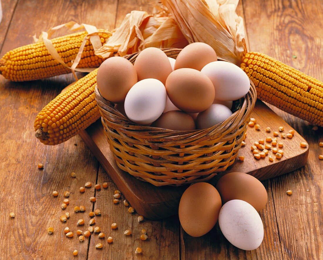 A still life featuring brown and white eggs in a basket