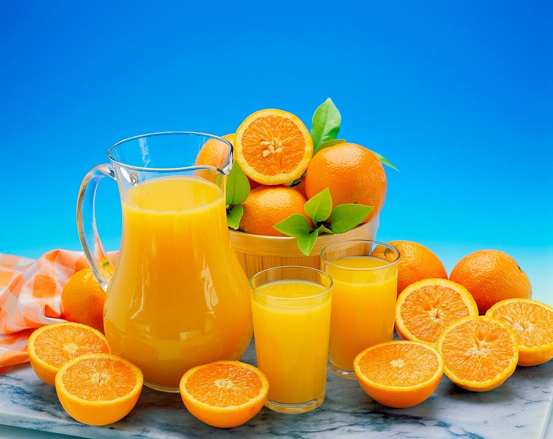 Stillleben mit Orangen und frisch gepresstem Orangensaft