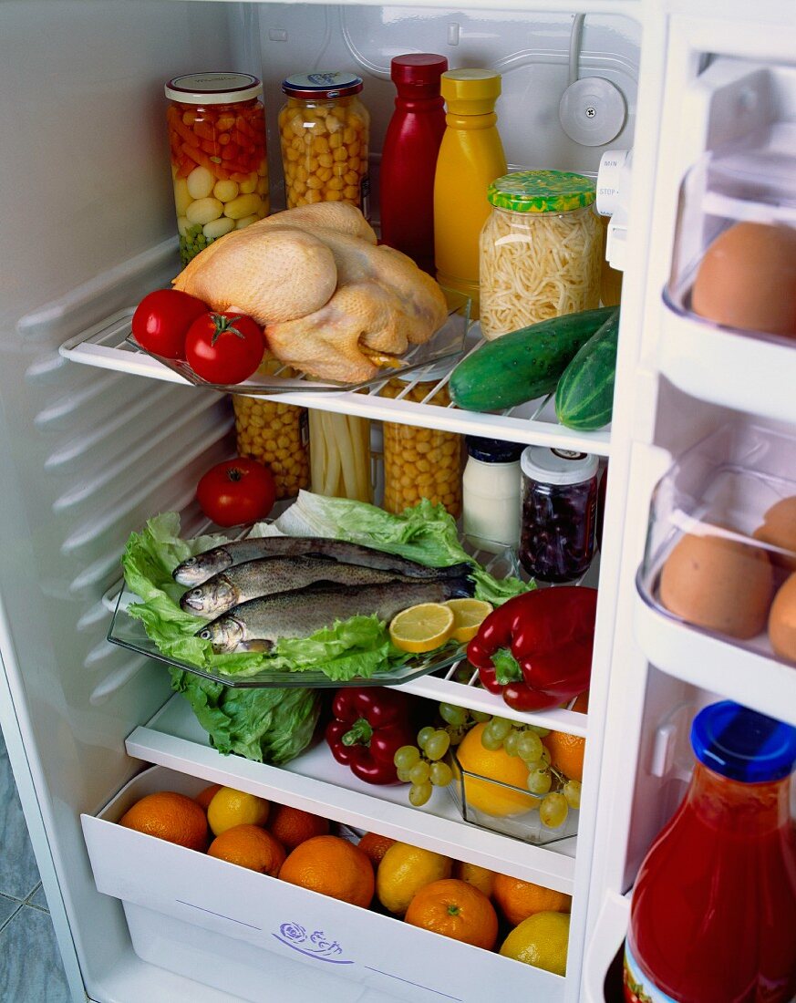 A refrigerator filled with assorted foodstuffs