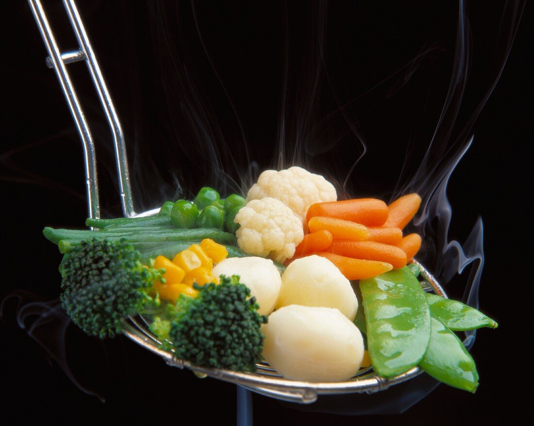 Steamed vegetables in a ladle
